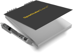 Carnet de notes à spirale noir et gris posé sur un coin avec un stylo argenté, symbolisant la planification d'événement.